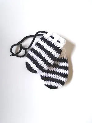 Black and white striped crochet baby mittens.