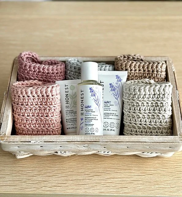 A set of washcloths folded in a wooden tray.