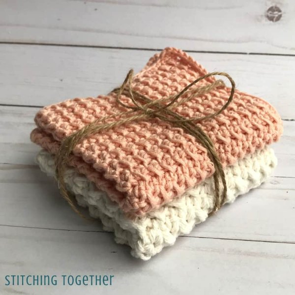 A stack of crochet washcloths tied with string.