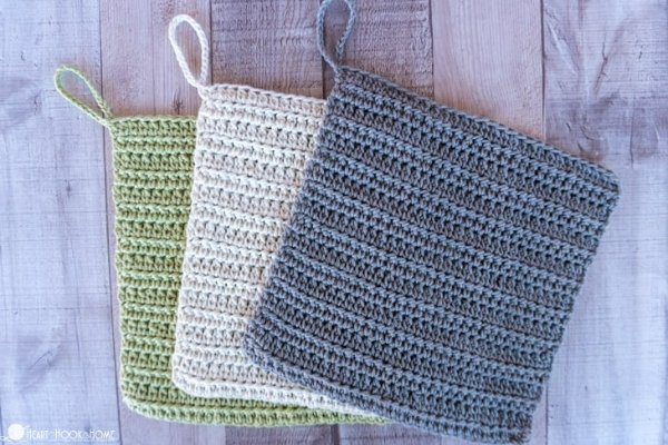 A set of three crochet washcloths with hanging loops.