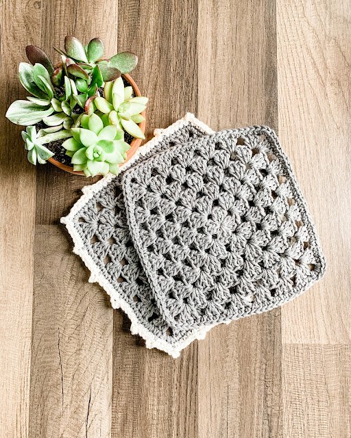 Two grey crochet washcloths.