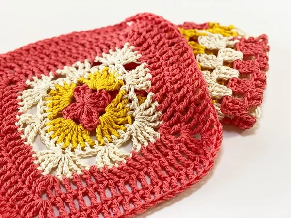 Brightly coloured granny square washcloths.