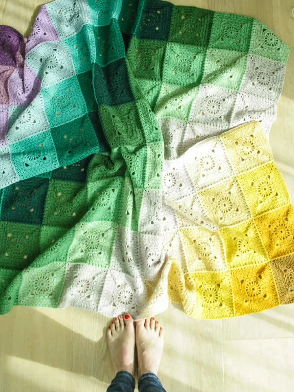 A granny square blanket with the motifs arranged to create a colour gradient effect.