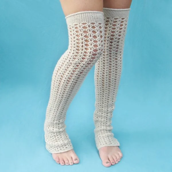 Over-the knee, long leg warmers crocheted in a lacy stitch pattern.