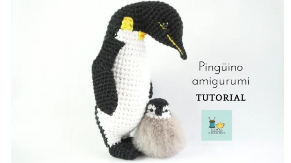 A realistic looking adult crochet penguin and a baby penguin.