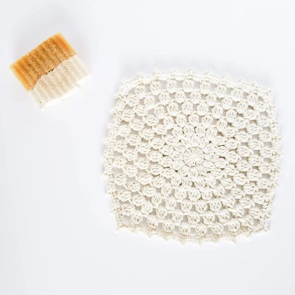 A white sunburst granny square washcloth.