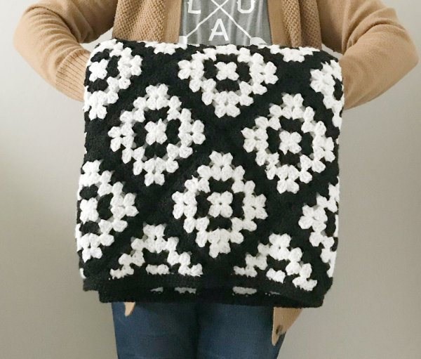 A black and white granny square blanket.