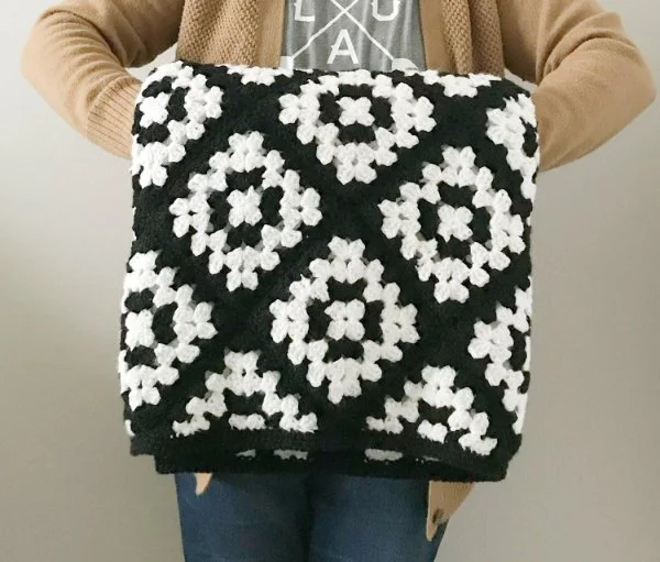 A black and white granny square blanket.