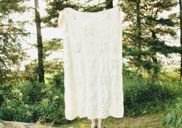 An all white granny square blanket.