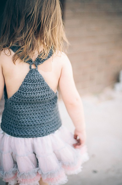 Back view of a toddler wearing a halter neck crochet baby top.