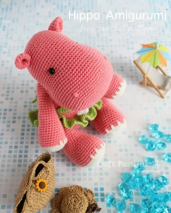 A pink crochet hippo wearing a bikini.