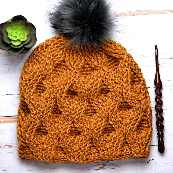 A textured crochet beanie with crochet cable work.