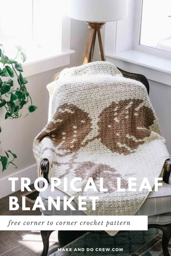A c2c crochet blanket with monstera leaf motifs in brown colours.
