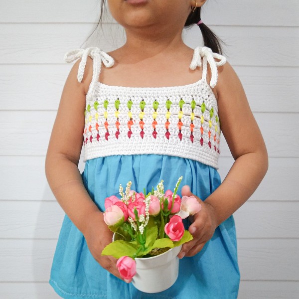 Girls' crochet top with fabric skirt.