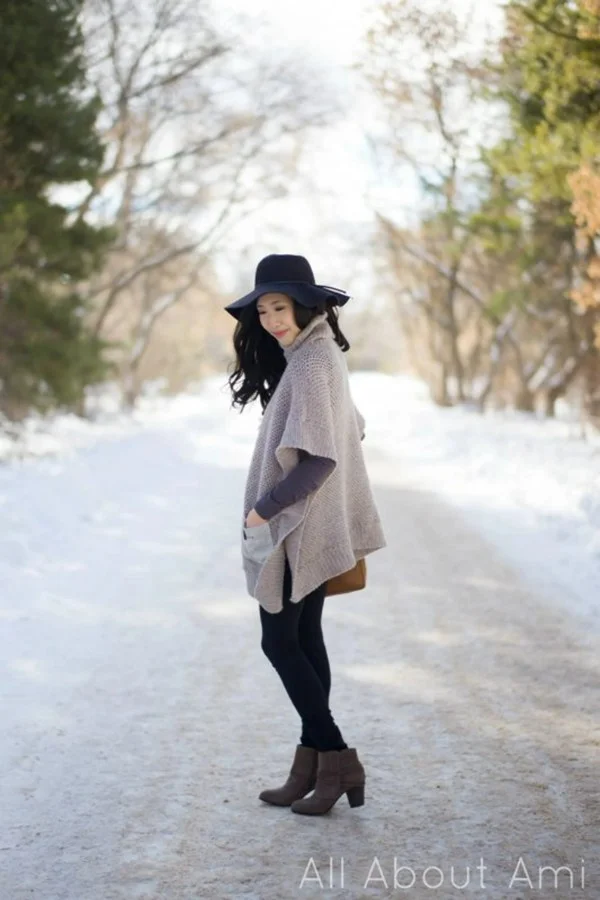 Side view of a woman wearing a modern crochet poncho with pockets.