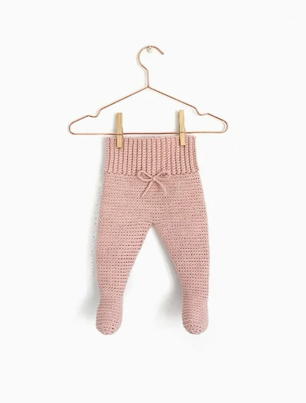 Pink crochet baby leggings on a hanger.