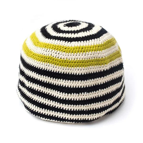 A black, white and yellow striped crochet pouf.