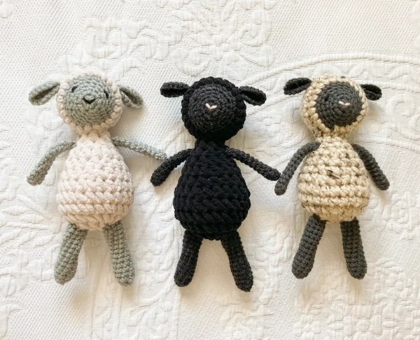 Three sweet crochet lamb toys in various colous.