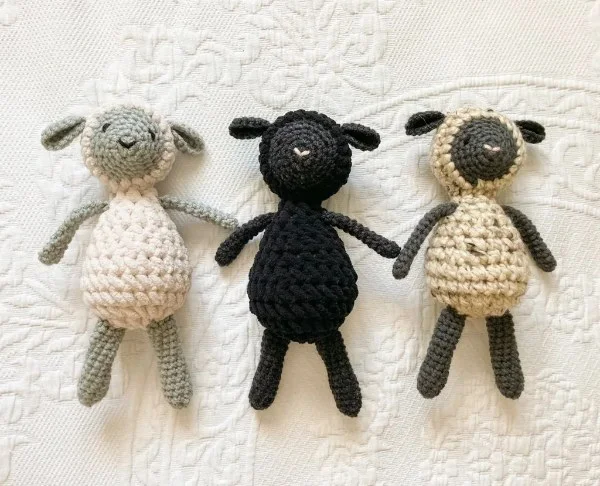 Three sweet crochet lamb toys in various colous.