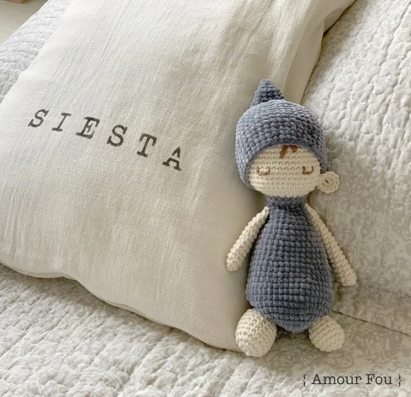 A sleepy crochet baby doll with a night cap.