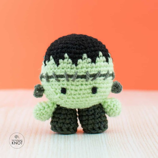 A mini crochet Frankenstein doll.