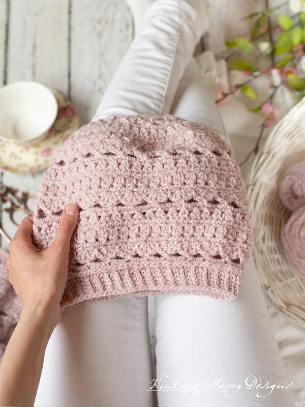 A pink crochet slouch beanie.