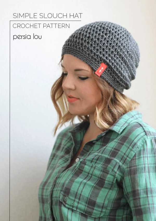 A woman wearing a grey crochet slouch hat with a simple brim.