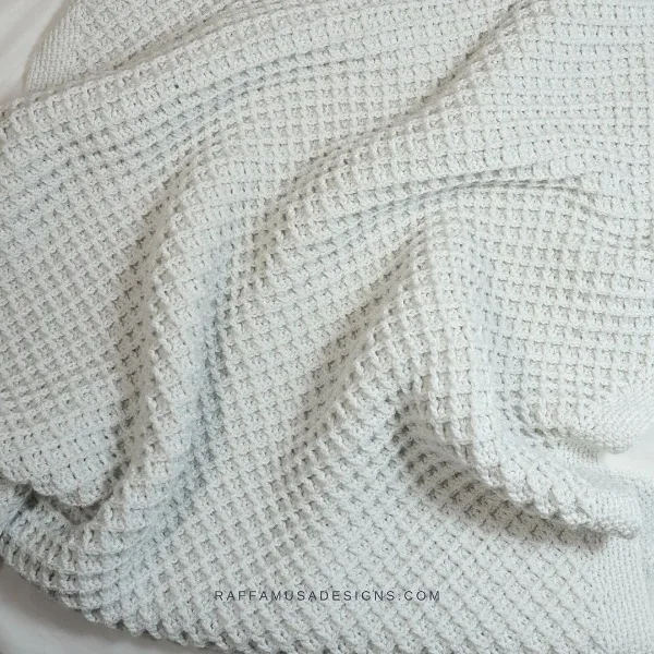 A white, textured waffle stitch c2c crochet blanket.