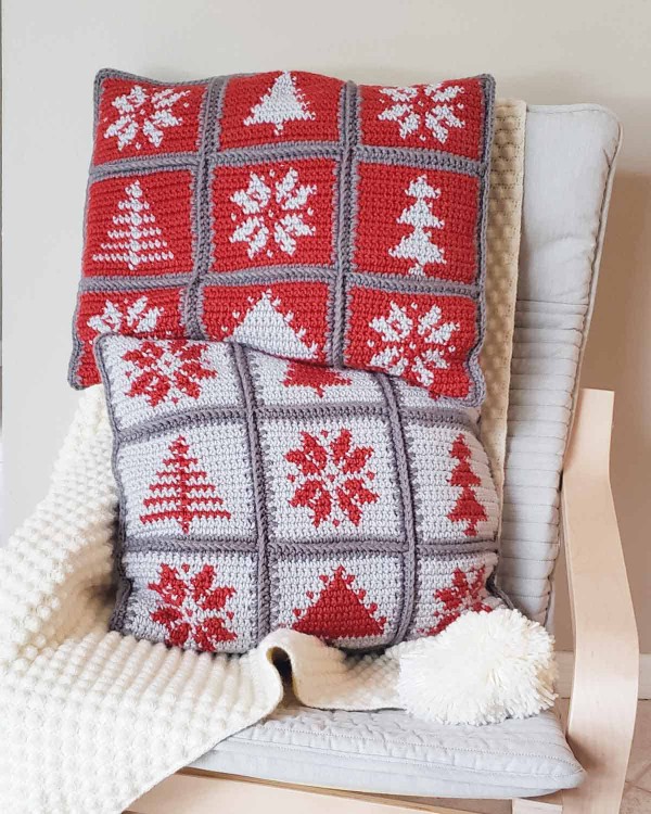 Two red and white crochet Christmas pillows worked in tapestry crochet squares.