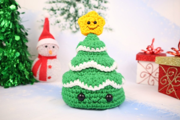 Christmas tree amigurumi with cute facial features.