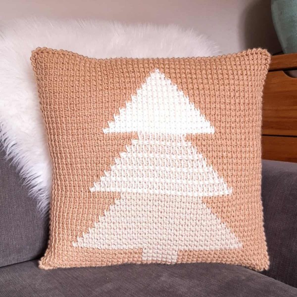 A Tunisian crochet pillow cover with a colour gradient Christmas tree motif.