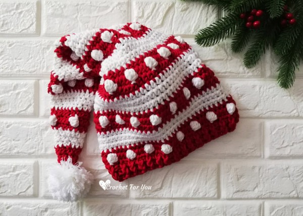 A red and white crochet santa hat with the bobble stitch.
