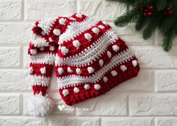 A red and white crochet santa hat with the bobble stitch.