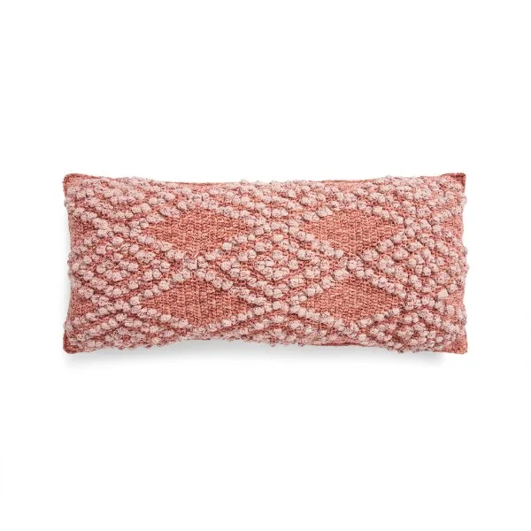 A pink-toned rectangular corchet piloow with a bobble stitch diamond design.
