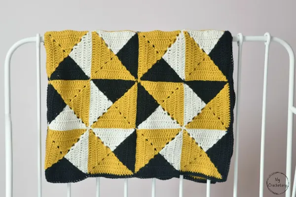 Pinwheel design crochet quilt.