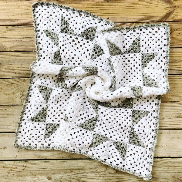 Crochet granny square blanket with a traditional star quilt design.