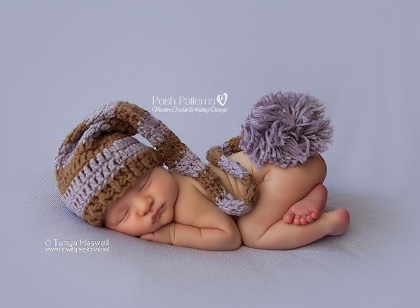 A newborn baby wearing a crochet stocking hat.