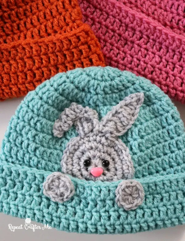A crochet beanie with a rabbit applique.