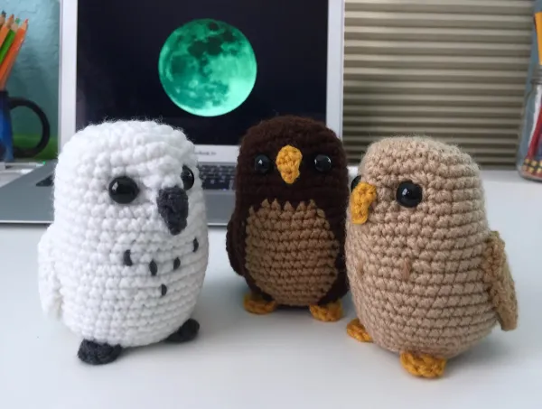 Three amigurumi owls in different colourways.