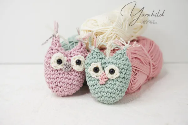 Beginner crochet owls in pink and blue.