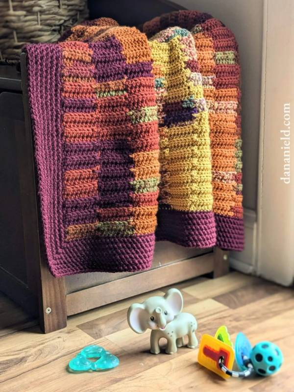 Colourful, small crochet temperature baby blanket.