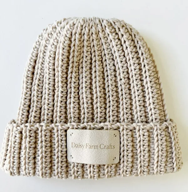 Beige coloured ribbed crochet beanie.