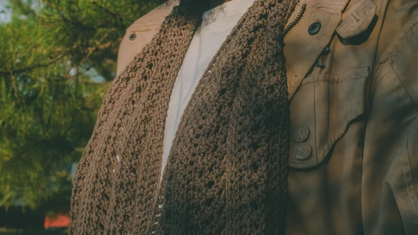 A brown scarf that is a hybrid of crochet and knit.