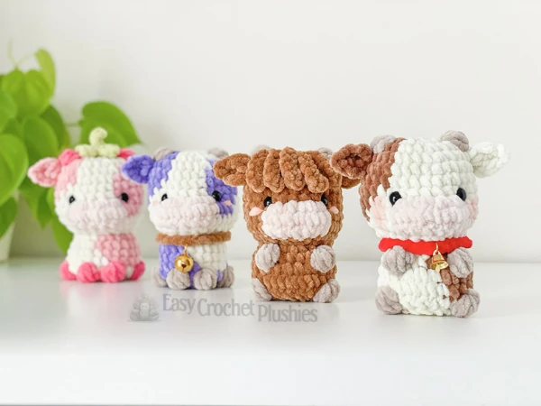 Four different mini crochet cow toys.
