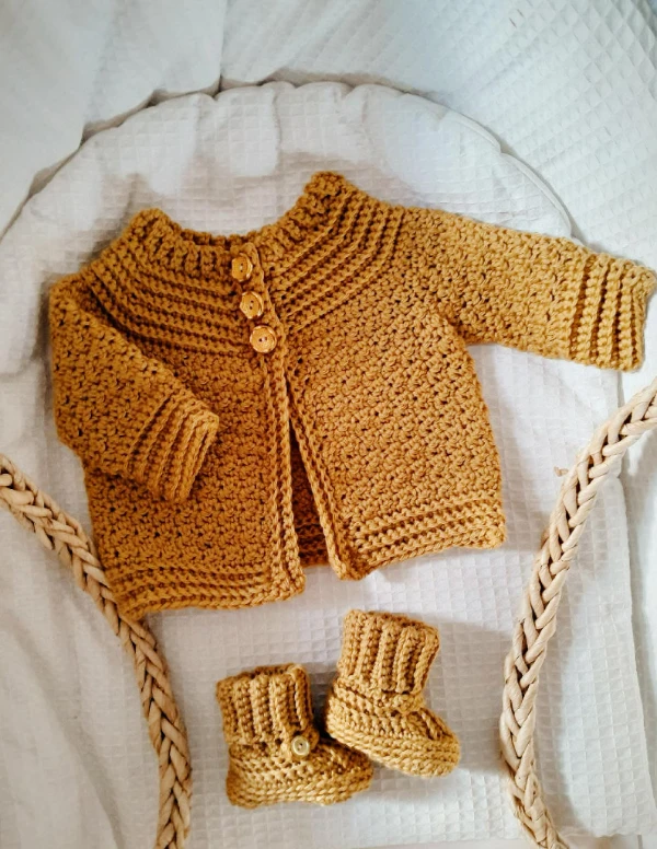 Ribbed yoke crochet baby cardigan and matching booties.
