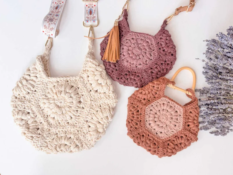 Three hexagon crochet bags in varying sizes and colours.