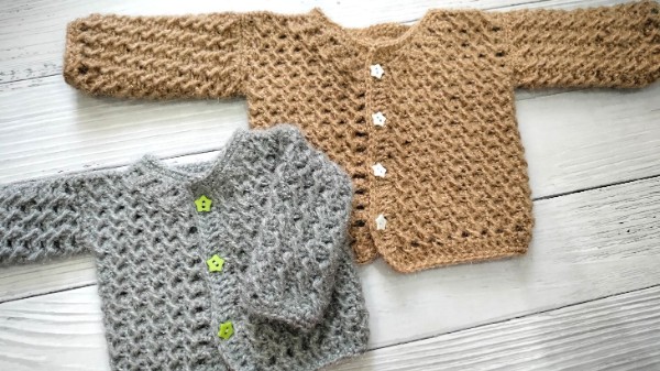 Two textured cross-stitch crochet baby cardigans for newborns.