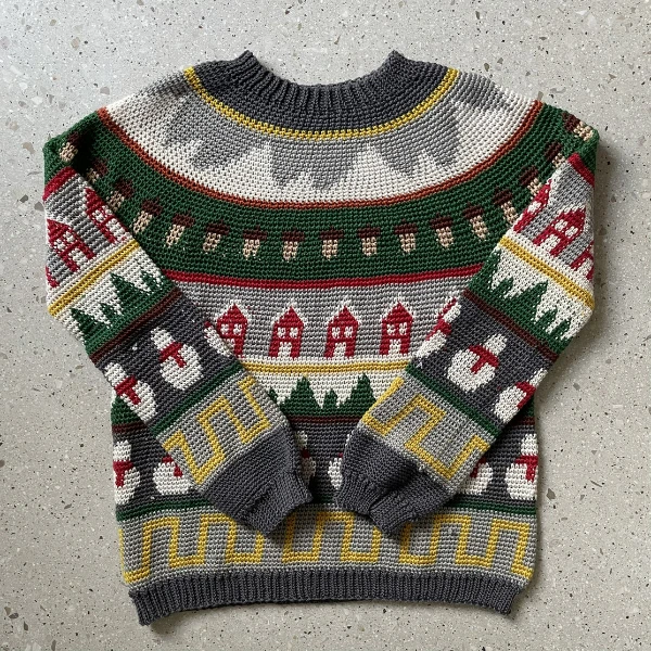 A crochet Christmas sweater with intricate colourwork patterns.