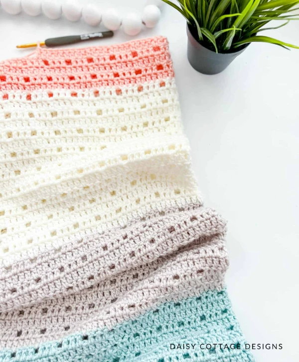A simple, striped, filet crochet baby blanket.