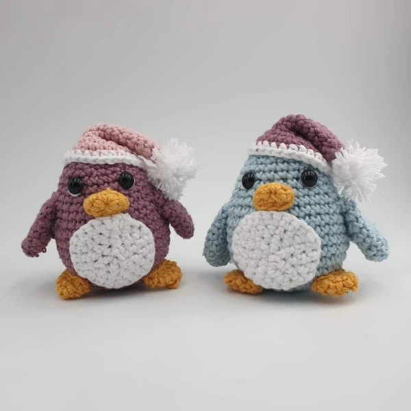Crochet penguins in Santa hats.